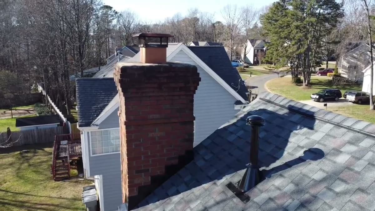 Aerial chimney and shingle detail from a drone flyover